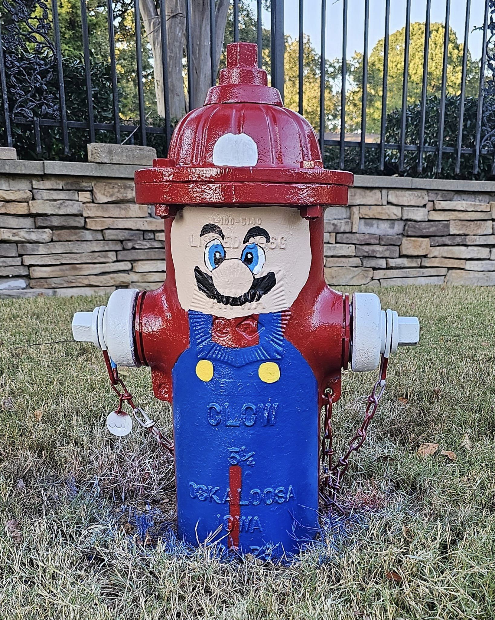 a fire hydrant painted in the likeness of Mario by Olive Branch Resident Ed Crumpler
