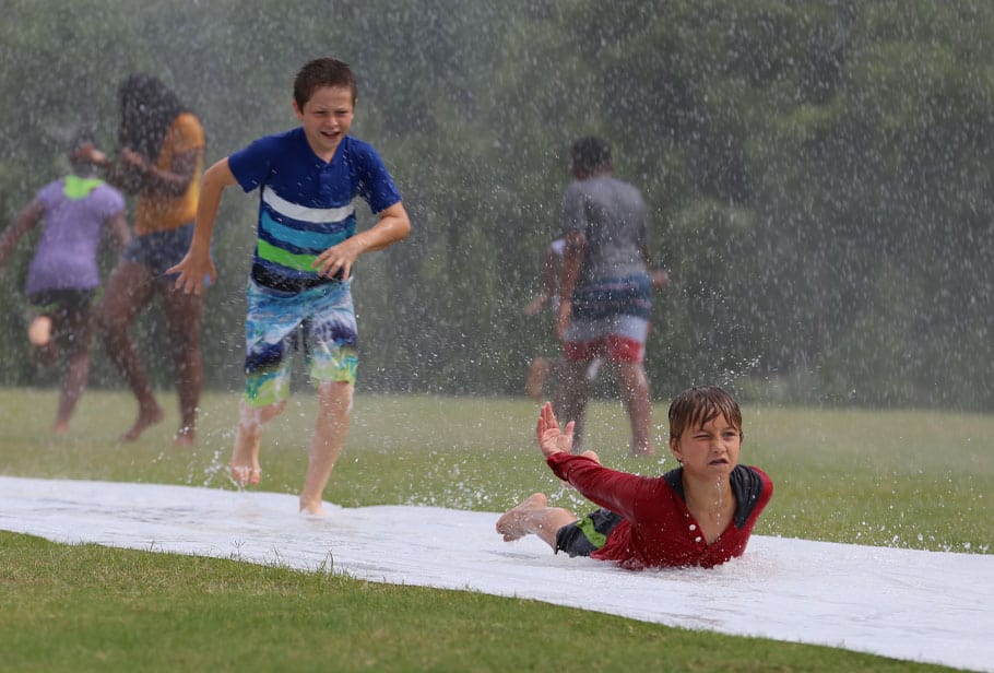 Two Kids Playing on a Slip and Slide