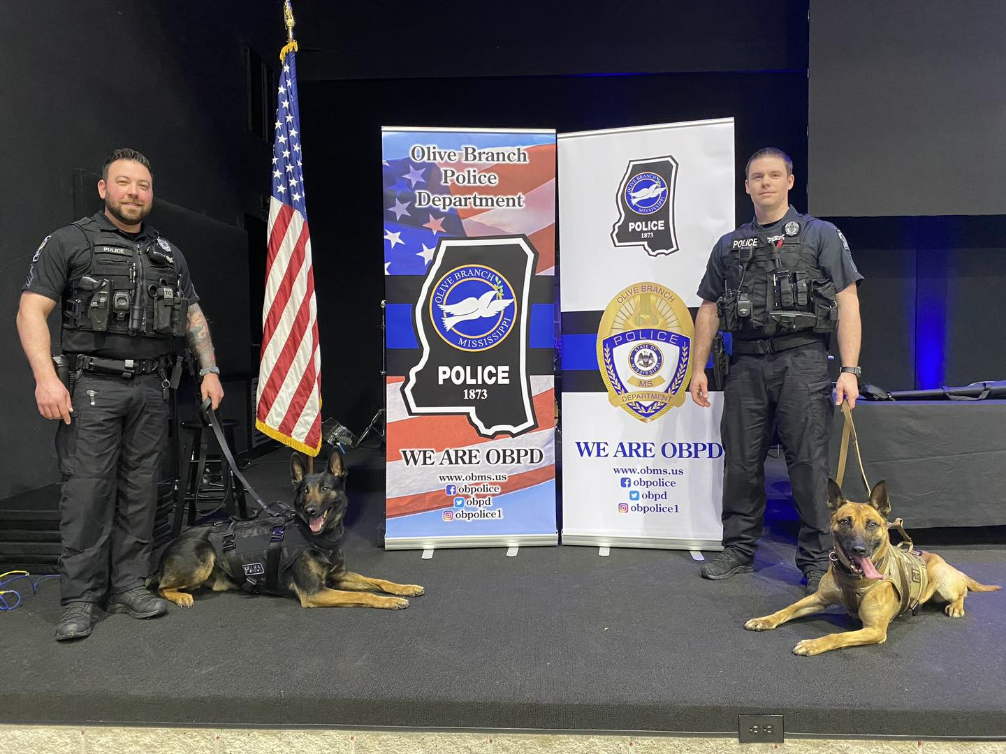  Sergeant Bryce Wardlaw, K-9 Flip, Sergeant Andrew White and K-9 Zak pose on stage 