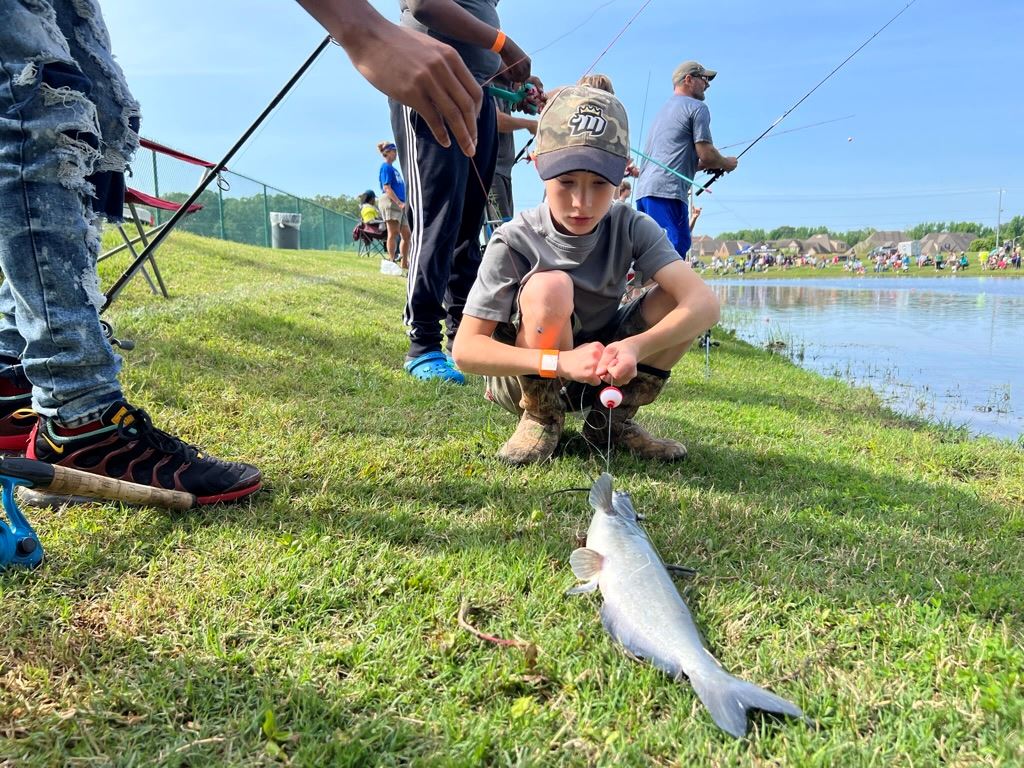 Boy shares a freshly caught catfish